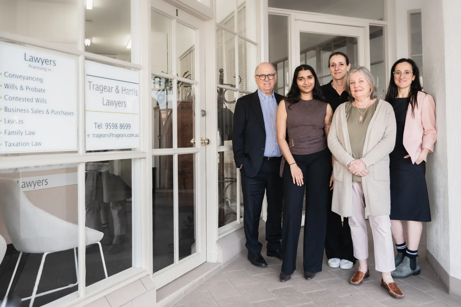 The Tragear & Harris team at the office entrance